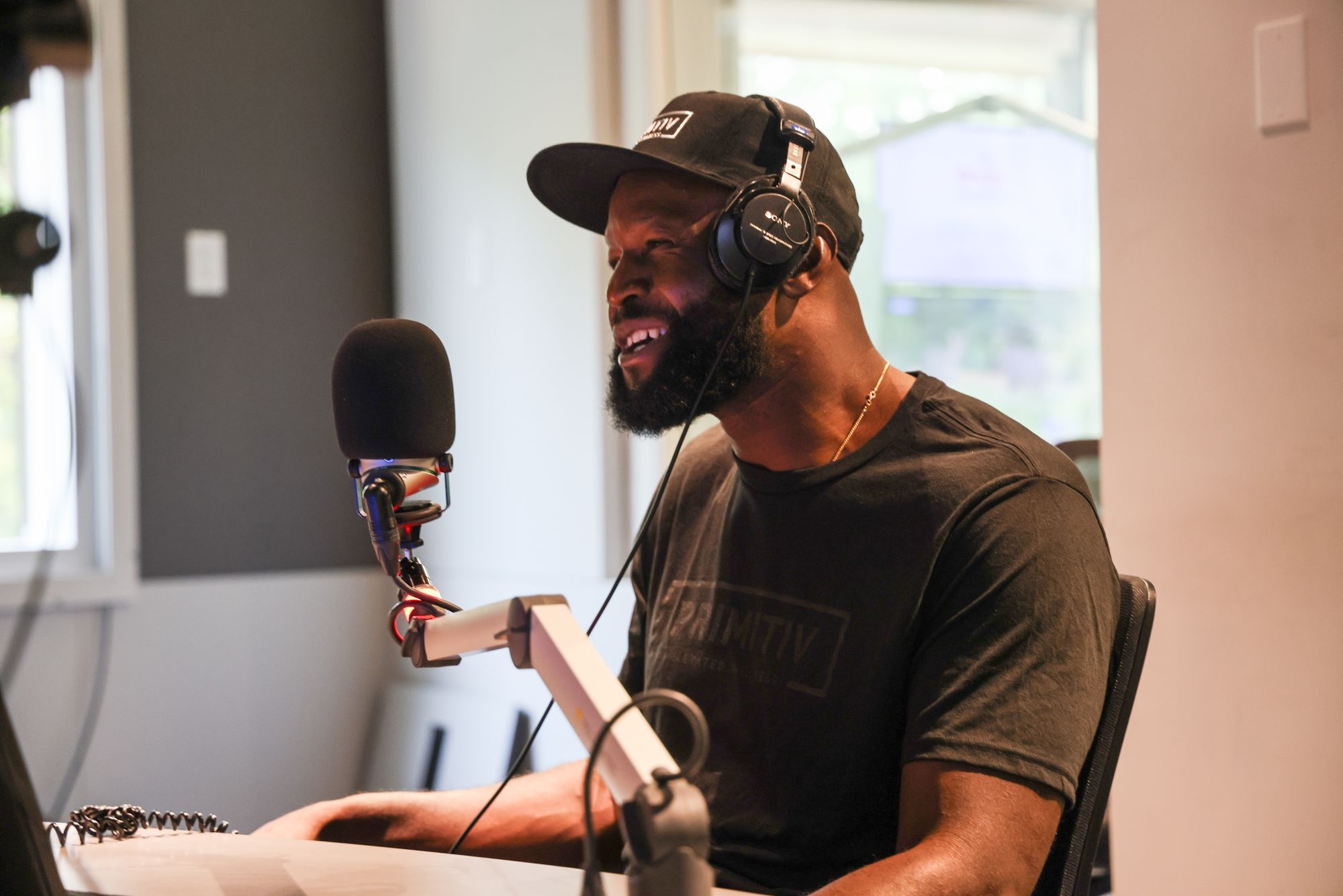 Gosder Cherilus laughing during a podcast conversation